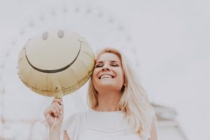 A Powerful Spell to Keep a Woman Away From Your Man 2025 woman holding a smiley balloon